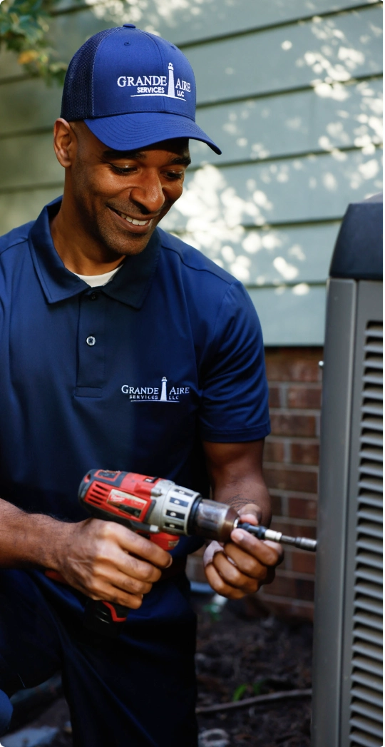 Grande Aire employee working on an HVAC unit