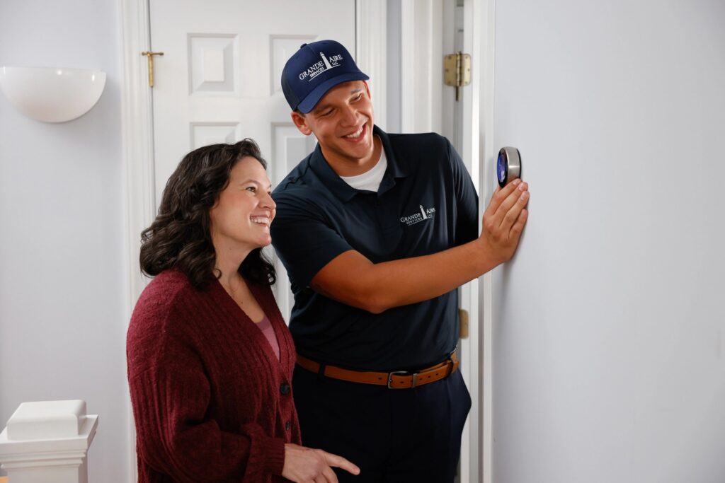 HVAC Technician with Customer at Smart Thermostat