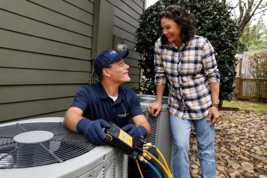 hvac-technician-and-customer-outdoor-ac-unit