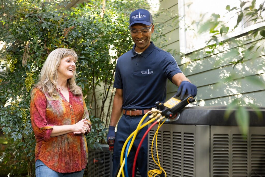 hvac-technician-with-customer-outdoor-ac-unit