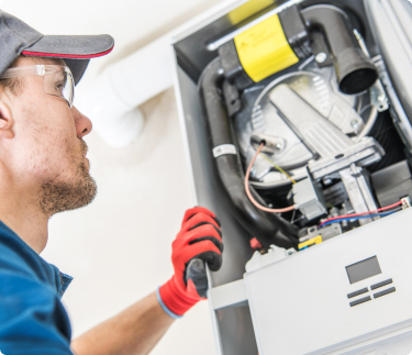 Grande Aire HVAC technician working on an HVAC unit