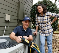 Grande Aire employee fixing an air conditioning