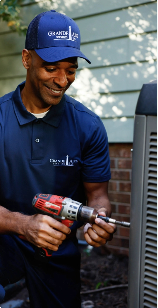 Grande Aire employee working on an HVAC unit