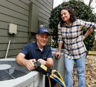 Grande Aire employee fixing an air conditioning