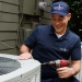 Grande Aire technician performing a seasonal tune-up on an AC unit
