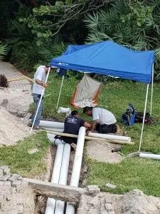 Grande Aire Service techs working on drainage and pipe system
